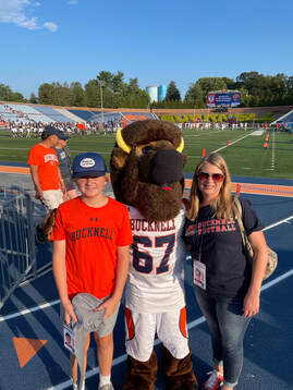 Mom and son with college mascot at football game